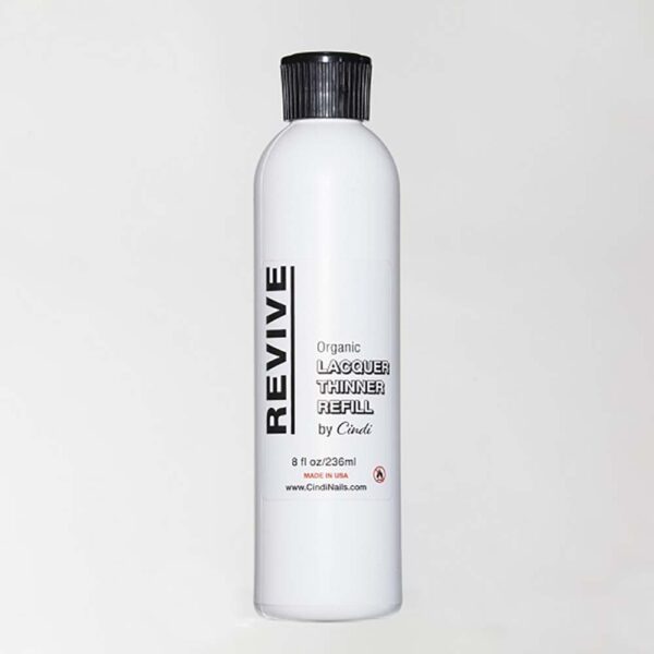 White Bottle Of Revive Organic Lacquer Thinner Refill By Cindi. Product Label Includes Volume, Ingredients, And Website Details.