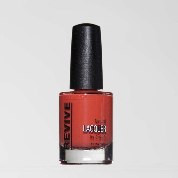 A Bottle Of "Revive" Natural Nail Lacquer In A Coral-red Shade.