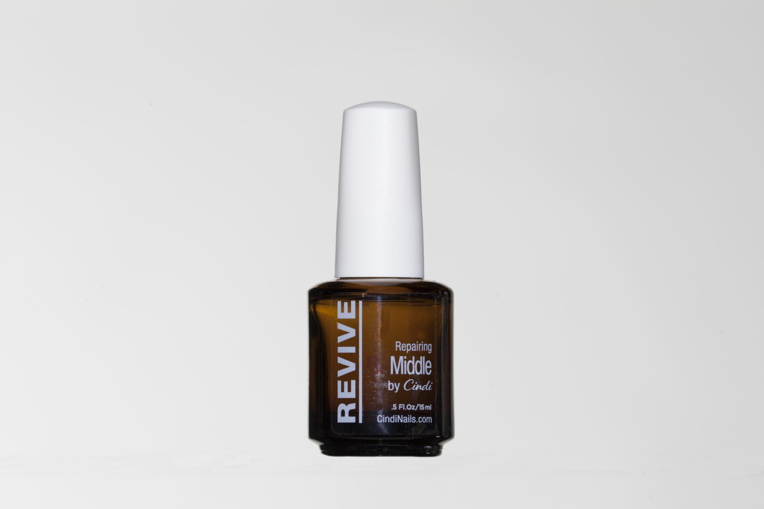 Nail Revive Repairing Middle By Cindi In Brown Glass Bottle With White Cap.