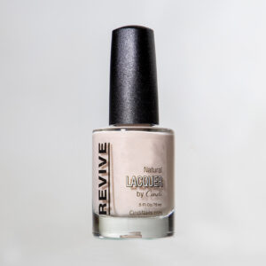 Nail Polish Bottle With A Light Beige Color, Labeled "Revive Natural Lacquer By Cindi" Isolated On A White Background.