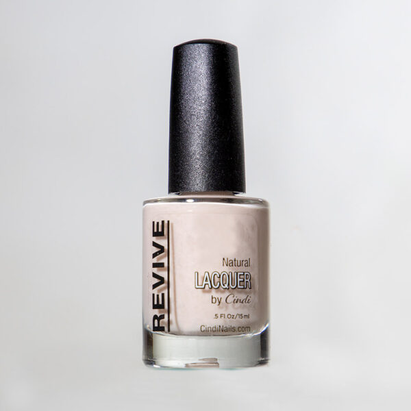 Nail Polish Bottle With A Light Beige Color, Labeled "Revive Natural Lacquer By Cindi" Isolated On A White Background.