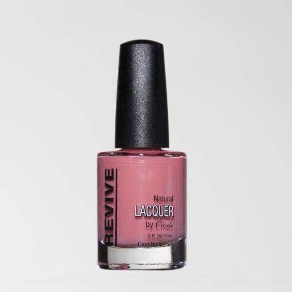 A Bottle Of "Revive" Natural Pink Nail Lacquer By Cindi, With A Black Cap, Against A White Backdrop.